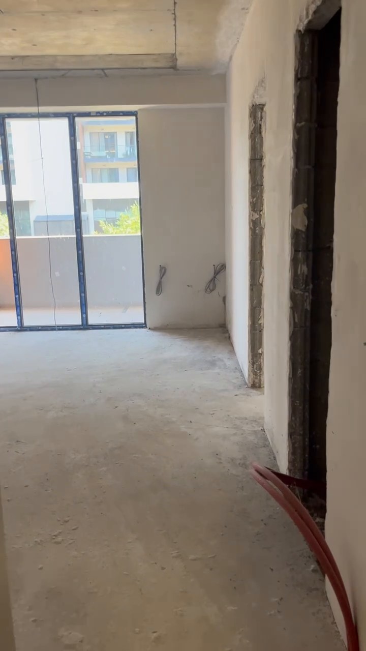 View from the entrance along the corridor toward the balcony glazing
